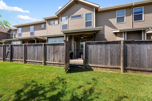 rear view of house with a yard