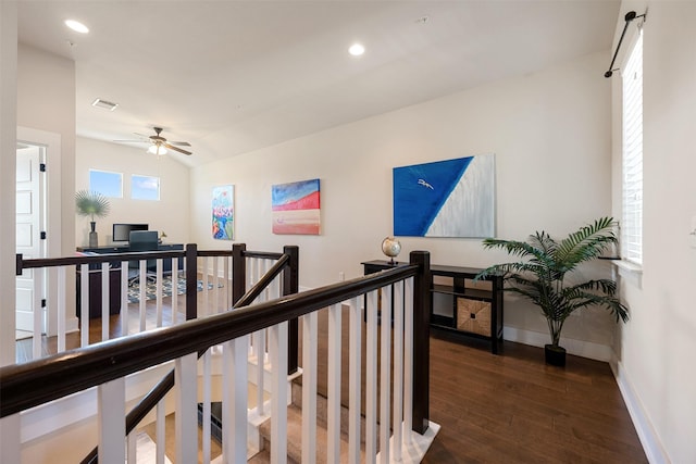 hallway with dark hardwood / wood-style flooring and vaulted ceiling