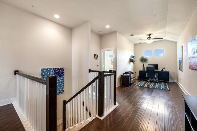 hall featuring dark hardwood / wood-style flooring and vaulted ceiling