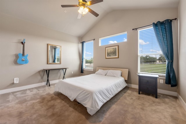 carpeted bedroom with multiple windows, vaulted ceiling, and ceiling fan