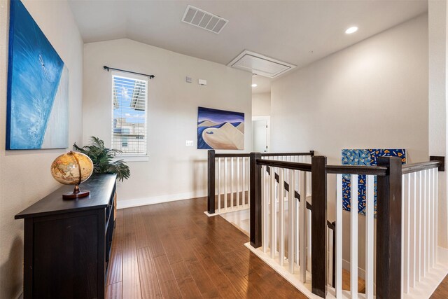 hallway with lofted ceiling and dark hardwood / wood-style floors