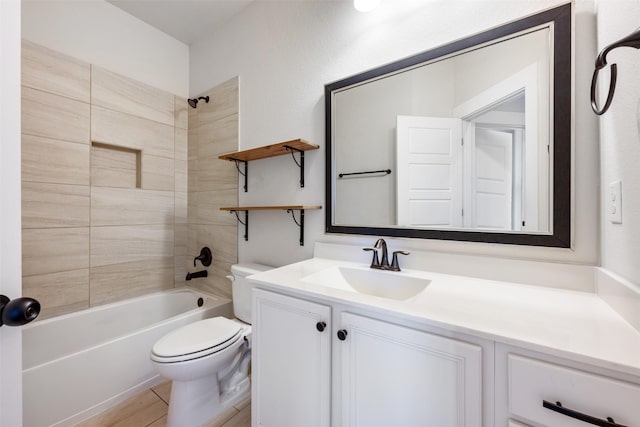 full bathroom featuring hardwood / wood-style flooring, tiled shower / bath, vanity, and toilet