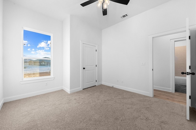 unfurnished bedroom featuring light colored carpet and ceiling fan