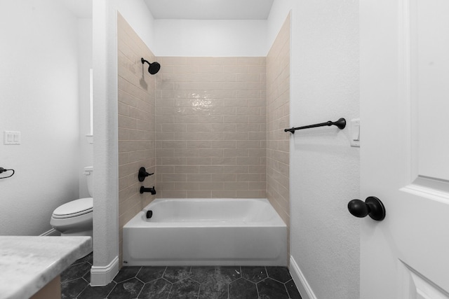 full bathroom featuring tiled shower / bath combo, toilet, and tile patterned floors