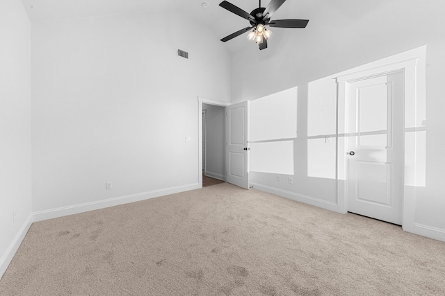 unfurnished bedroom with ceiling fan, light carpet, and high vaulted ceiling