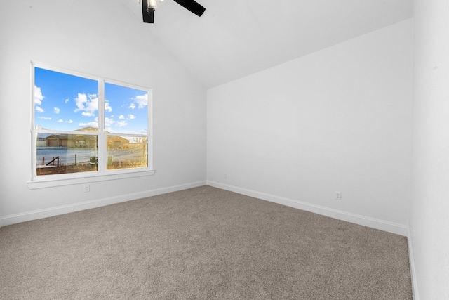 carpeted empty room featuring a water view, ceiling fan, and vaulted ceiling