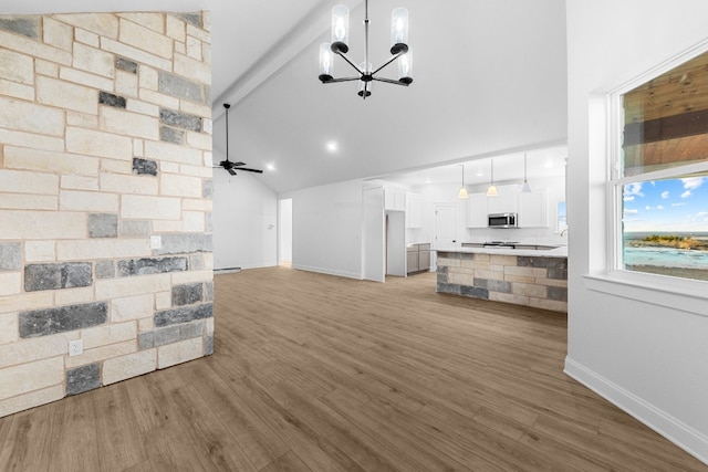 living room featuring high vaulted ceiling, light wood-type flooring, ceiling fan with notable chandelier, and beam ceiling