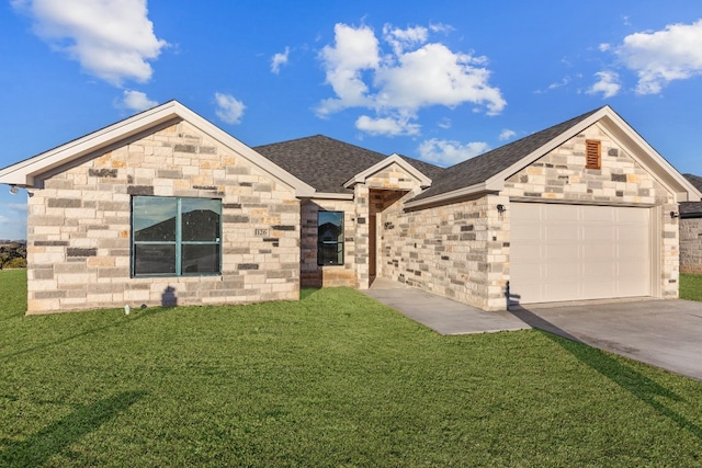 view of front of property with a garage and a front lawn