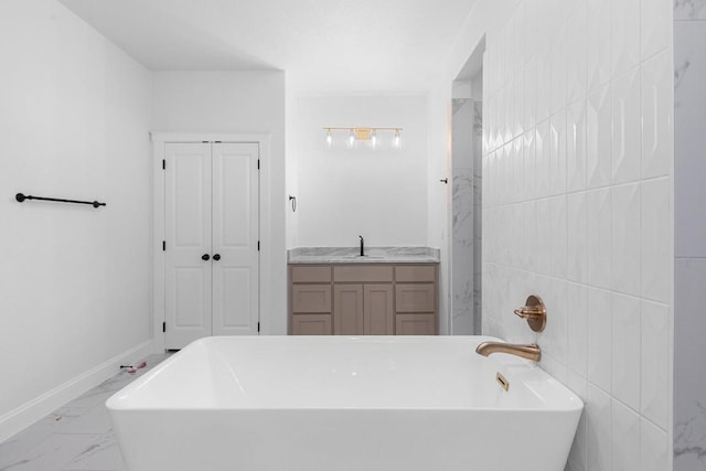 bathroom with a washtub, vanity, and tile walls