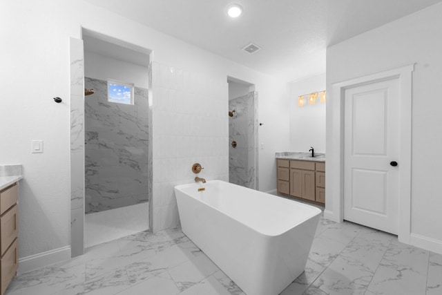 bathroom featuring tiled shower, vanity, and tile patterned floors