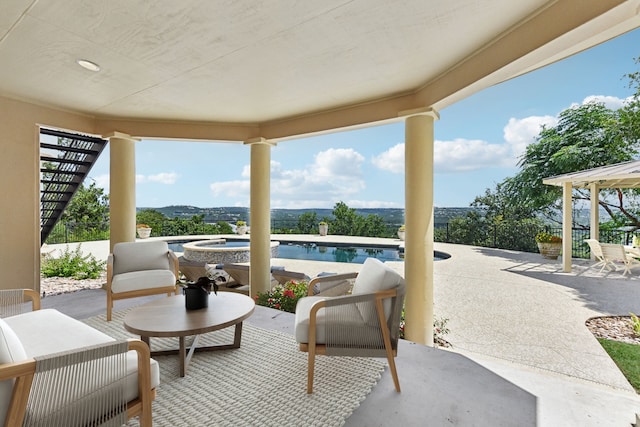 view of patio / terrace featuring a swimming pool with hot tub and a mountain view