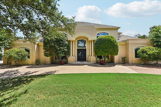 mediterranean / spanish home featuring a front yard