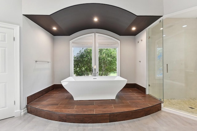 bathroom featuring shower with separate bathtub