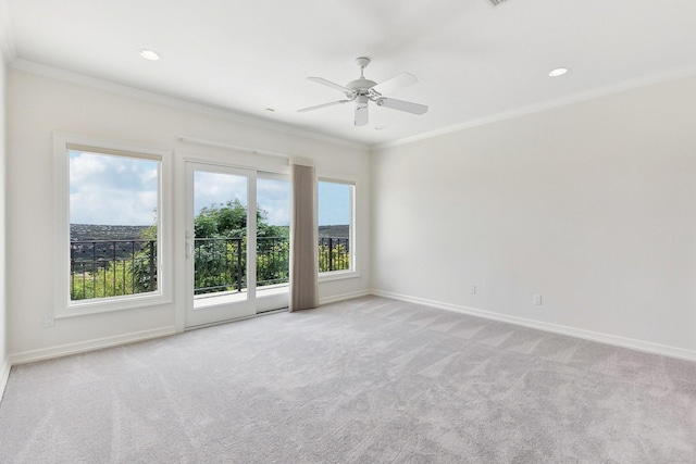 empty room featuring ceiling fan, light carpet, and crown molding