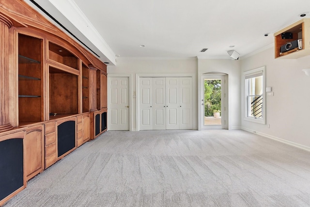 unfurnished living room featuring crown molding and light colored carpet