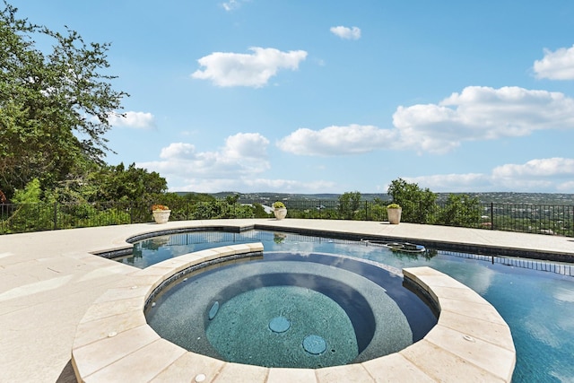 view of pool with an in ground hot tub