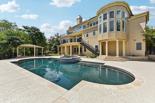 view of pool with an in ground hot tub and a patio area