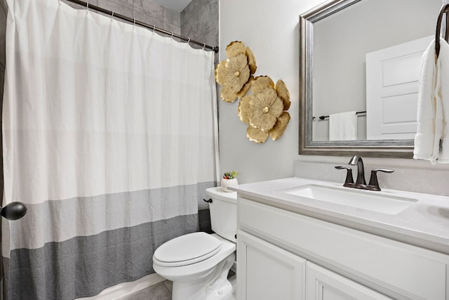 bathroom with vanity, a shower with shower curtain, and toilet