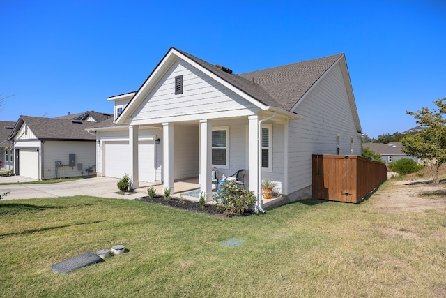 view of front of home with a porch, a garage, and a front yard