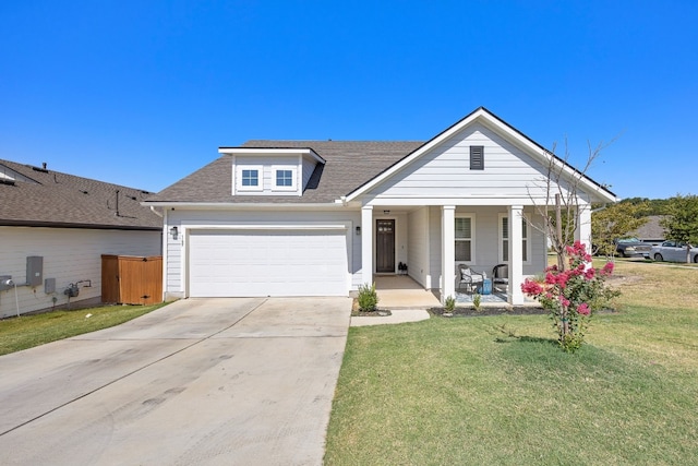 view of front of house featuring a garage, covered porch, and a front yard