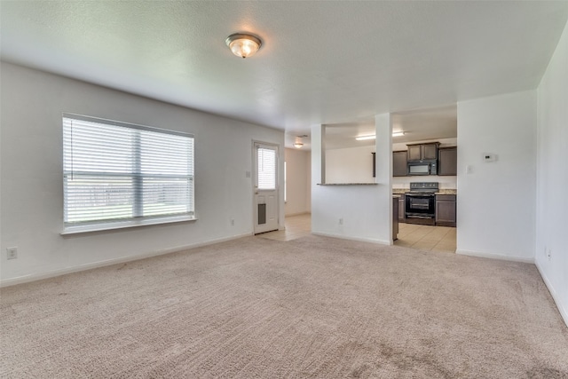 unfurnished living room featuring light tile patterned floors