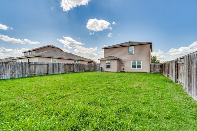 rear view of property with a yard