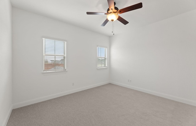 carpeted spare room with ceiling fan and a wealth of natural light