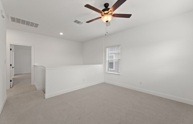 unfurnished room featuring light carpet and ceiling fan