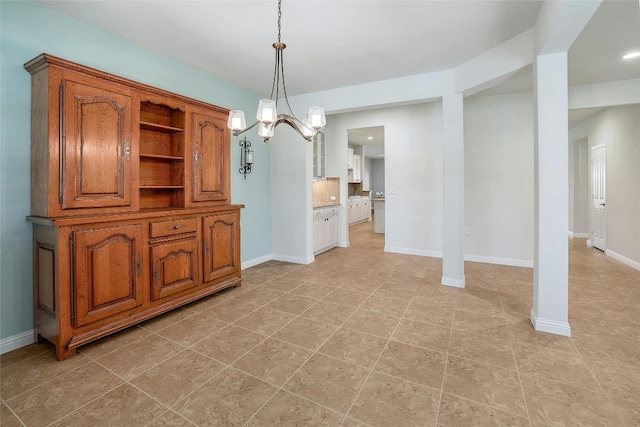 unfurnished dining area with a chandelier