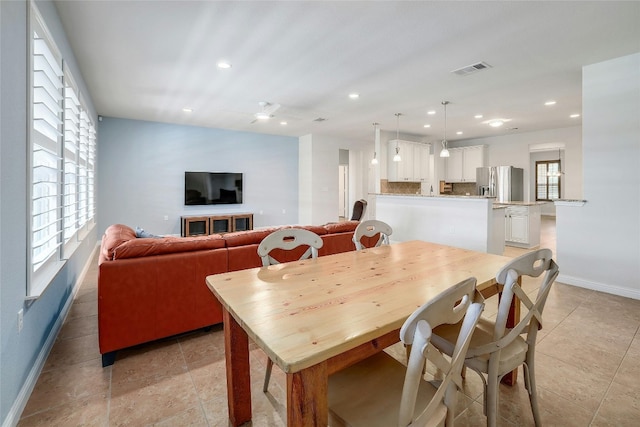 tiled dining area with a wealth of natural light