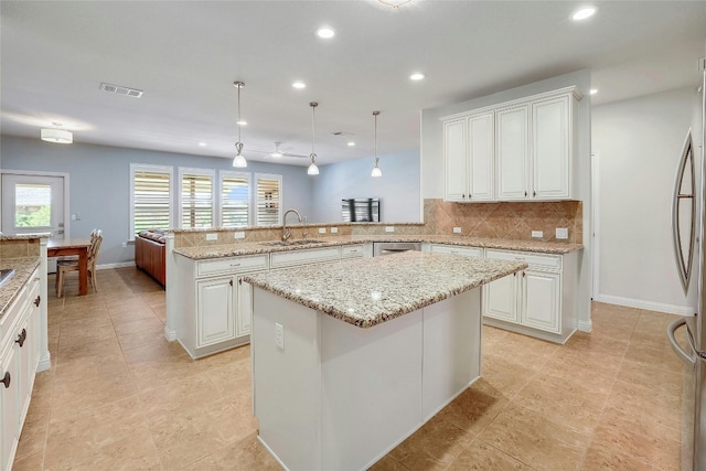 523 Mckittrick Ridge Rd, Georgetown, TX 78633 - kitchen with recessed lighting, a sink, visible vents, backsplash, and a peninsula