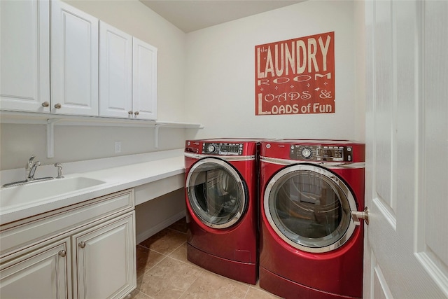 laundry area with separate washer and dryer, sink, light tile patterned floors, and cabinets