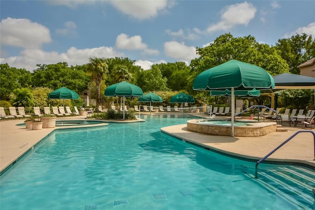 view of swimming pool with a patio area and a hot tub