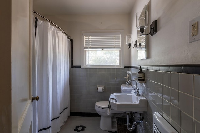 bathroom featuring sink, tile walls, a shower with shower curtain, and toilet