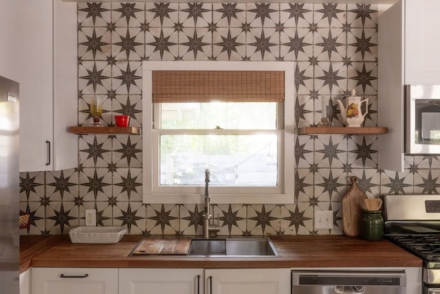 kitchen featuring white cabinetry, appliances with stainless steel finishes, and sink