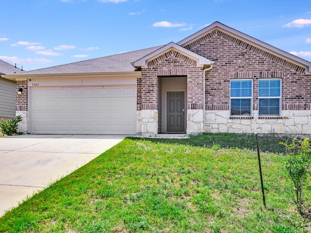 single story home featuring a garage and a front yard