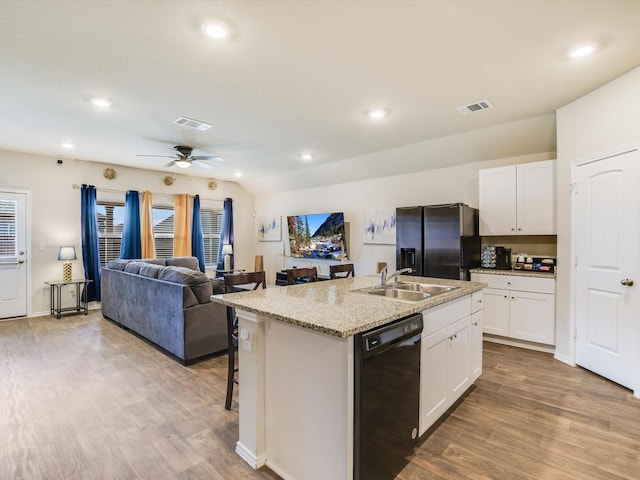 kitchen with black dishwasher, stainless steel fridge with ice dispenser, white cabinetry, sink, and a center island with sink