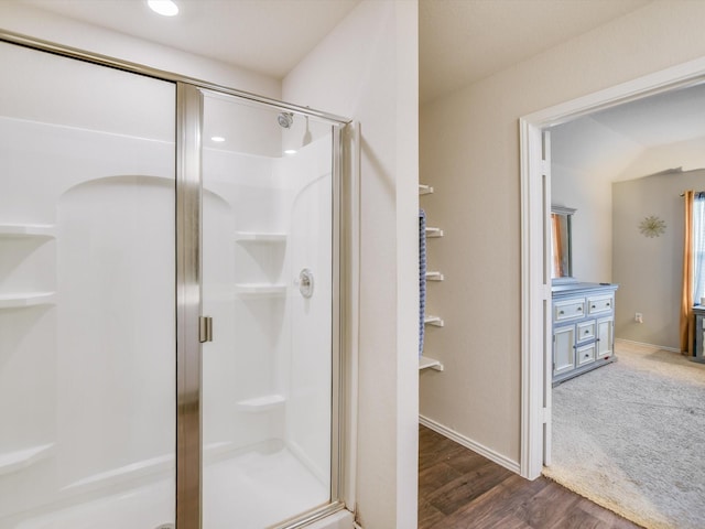 bathroom with wood-type flooring and walk in shower