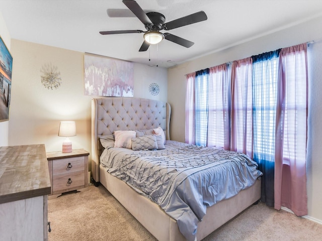 bedroom featuring light carpet and ceiling fan