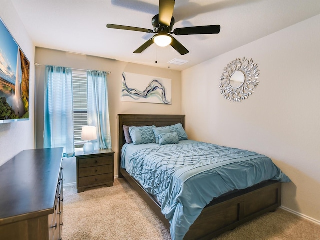 bedroom with ceiling fan and light colored carpet