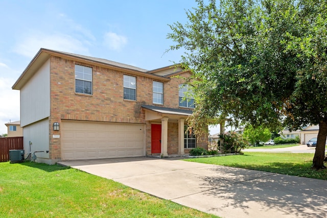 view of front of home featuring a garage, a front lawn, and central AC