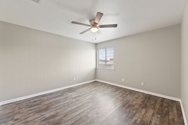 unfurnished room with ceiling fan and dark hardwood / wood-style flooring