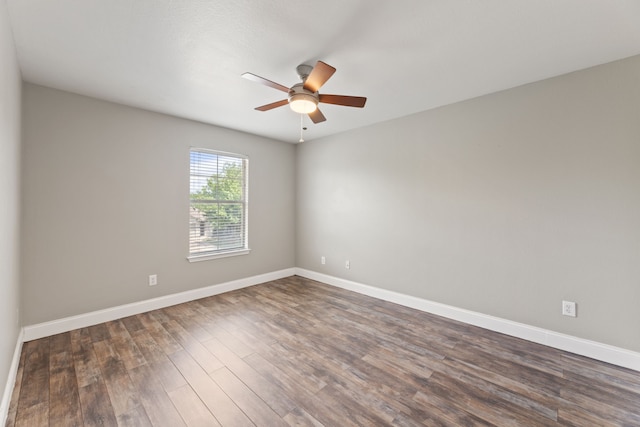 spare room featuring ceiling fan and dark hardwood / wood-style flooring