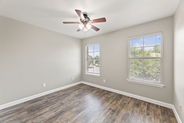 empty room featuring ceiling fan and dark hardwood / wood-style flooring