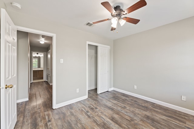 unfurnished bedroom featuring ceiling fan, a closet, and dark hardwood / wood-style floors