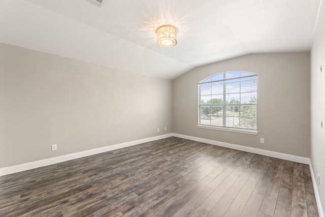 unfurnished room with vaulted ceiling and dark hardwood / wood-style floors