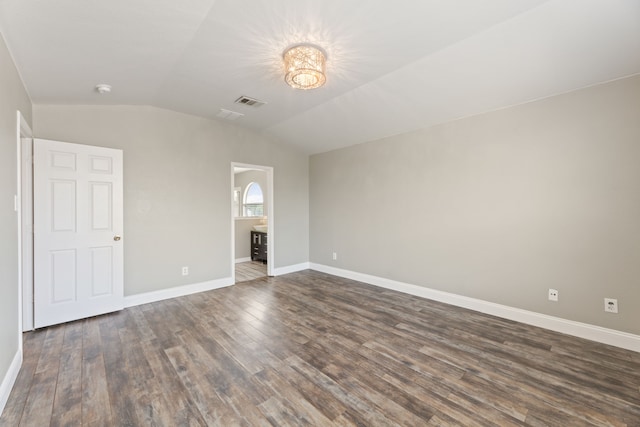 interior space featuring dark wood-type flooring and lofted ceiling