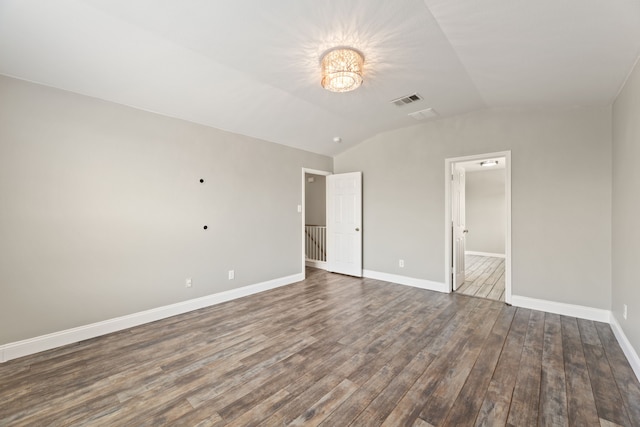 unfurnished bedroom featuring dark wood-type flooring and lofted ceiling