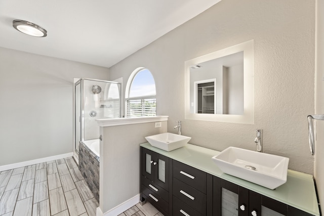 bathroom featuring shower with separate bathtub and vanity