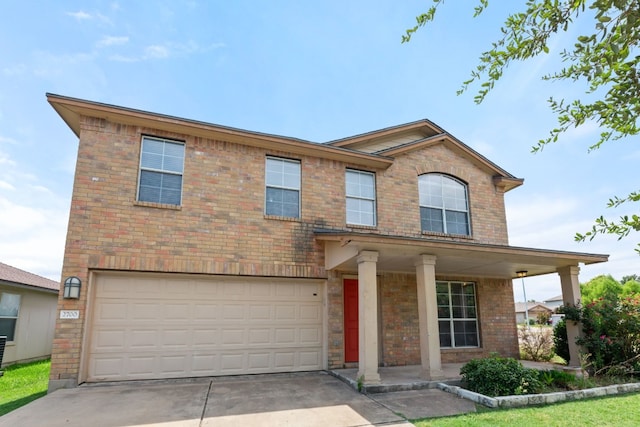 2700 Breezy Point Cv, Round Rock, TX 78665 - view of front facade with a garage, concrete driveway, covered porch, and brick siding